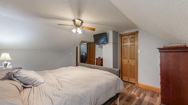 38184 County 47th Blvd, Goodhue, MN 55027 - bedroom with wood finished floors, a textured ceiling, lofted ceiling, a ceiling fan, and baseboards