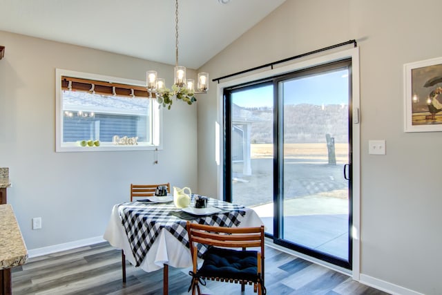 dining room with a notable chandelier, baseboards, vaulted ceiling, and dark wood-style flooring