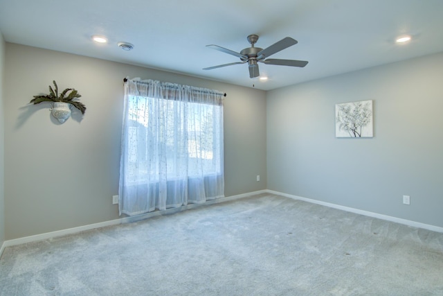 unfurnished room with recessed lighting, light colored carpet, a ceiling fan, and baseboards