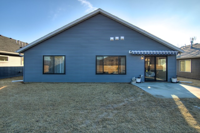 back of house featuring a patio area and a yard