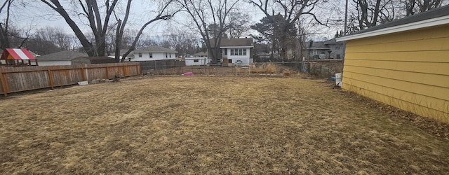 view of yard with a fenced backyard and a residential view