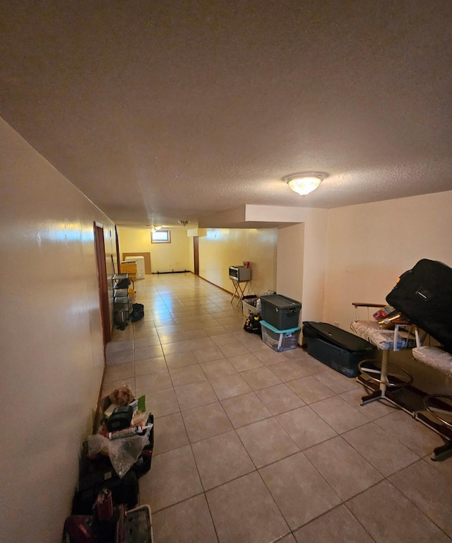 interior space with light tile patterned floors and a textured ceiling