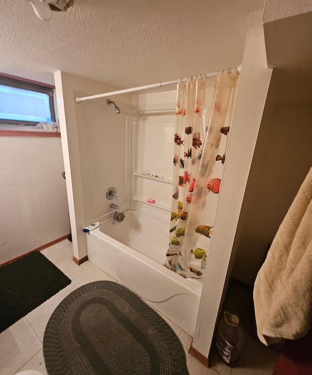 bathroom featuring tile patterned floors, a textured ceiling, baseboards, and shower / bath combo with shower curtain