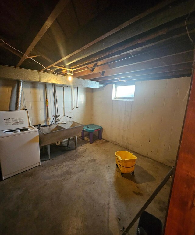 basement with washer / clothes dryer and a sink