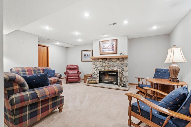 carpeted living room featuring a stone fireplace, recessed lighting, visible vents, and baseboards