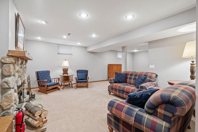 living area with a textured ceiling, recessed lighting, a fireplace, carpet flooring, and baseboards