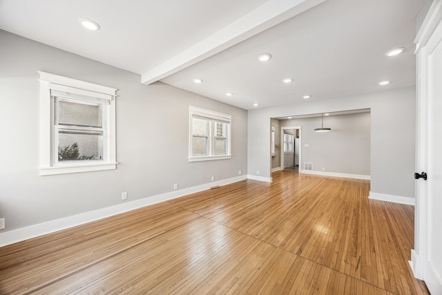 empty room featuring recessed lighting, beamed ceiling, light wood-style flooring, and baseboards