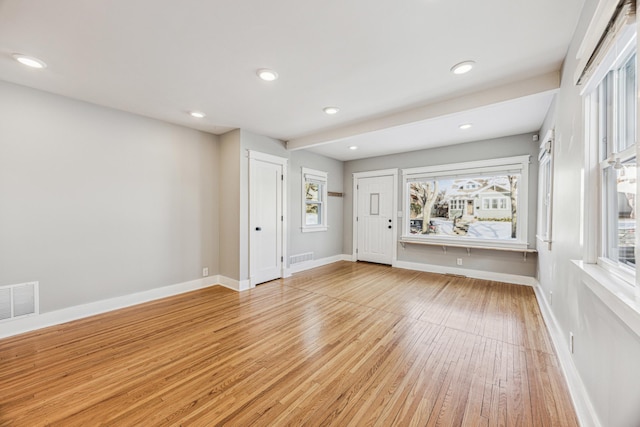 interior space with a wealth of natural light, light wood finished floors, visible vents, and baseboards