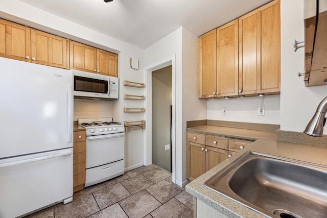 kitchen with white appliances, light countertops, a sink, and light tile patterned floors