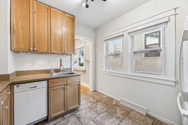 kitchen with light tile patterned floors, visible vents, a sink, dishwasher, and baseboards