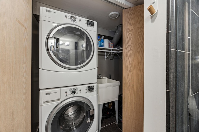 washroom featuring laundry area and stacked washer / dryer