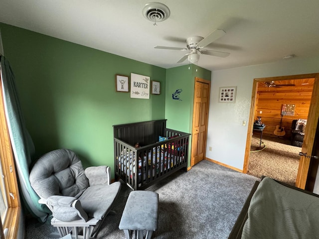 carpeted bedroom with baseboards, visible vents, and a ceiling fan