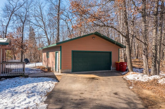 snow covered garage with a garage