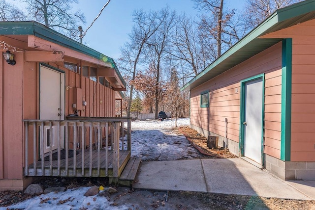 view of side of property with fence and a deck