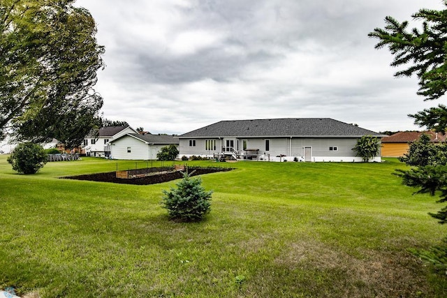 rear view of property with a yard