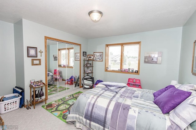 carpeted bedroom with a closet