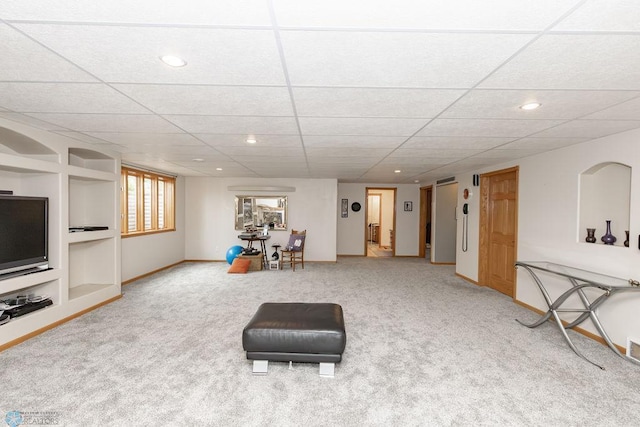 living area featuring carpet floors, built in shelves, baseboards, and recessed lighting