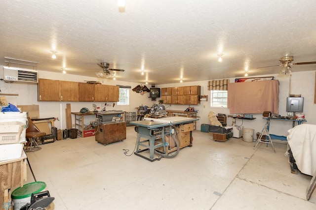 garage with ceiling fan, electric panel, and a workshop area