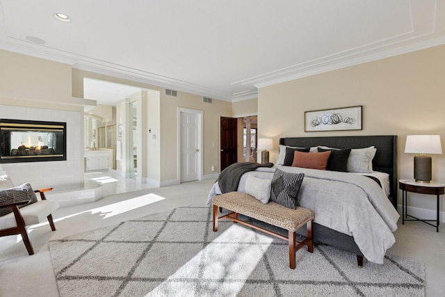 bedroom with crown molding, a fireplace, visible vents, and light colored carpet