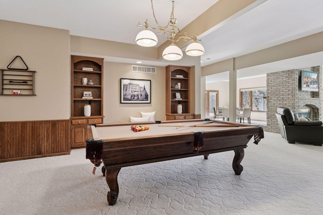 game room with light colored carpet, billiards, visible vents, built in features, and a brick fireplace