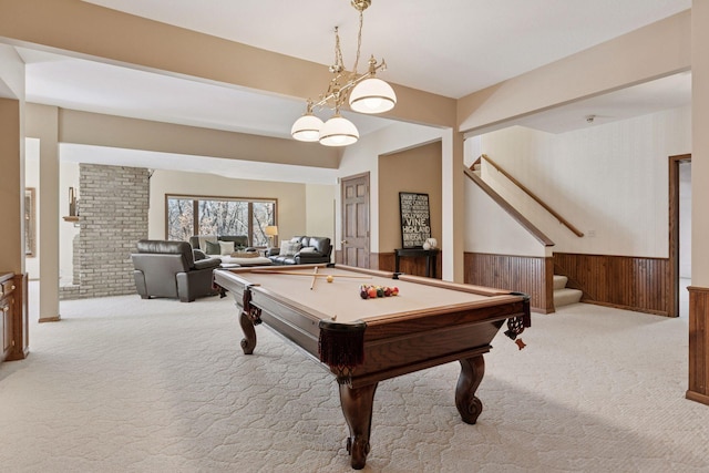 recreation room with light carpet, wood walls, pool table, and wainscoting