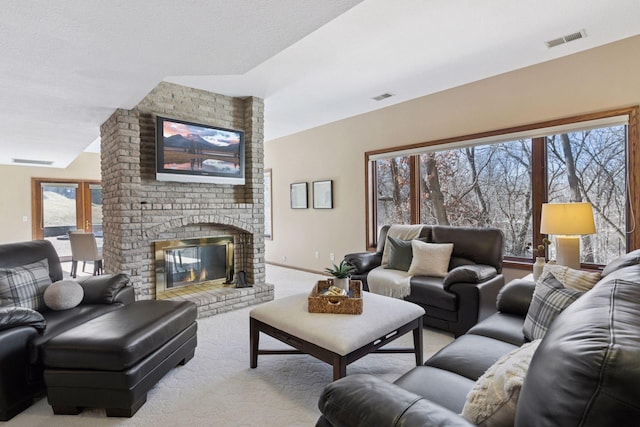 living area with light colored carpet, visible vents, and a fireplace