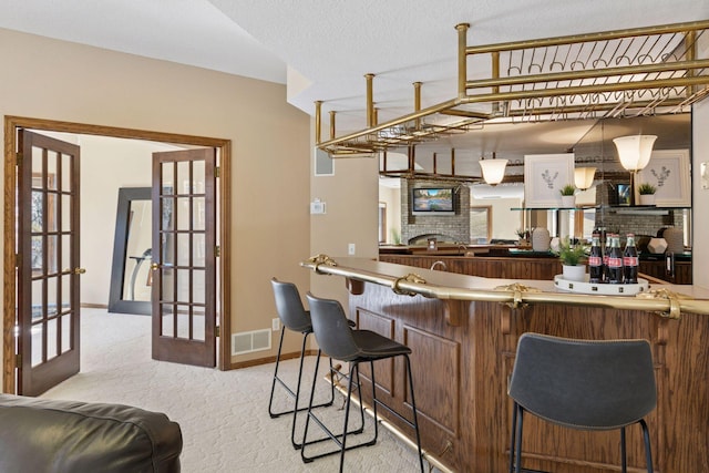 bar with light carpet, baseboards, visible vents, and french doors