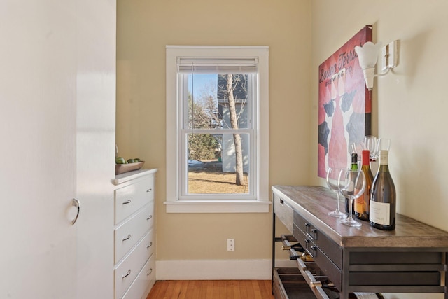 interior space featuring light wood-type flooring, plenty of natural light, and baseboards