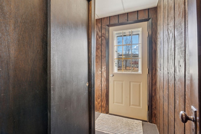 doorway featuring wood walls