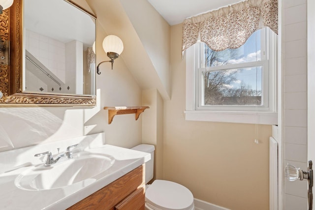 bathroom with toilet, a shower, and vanity