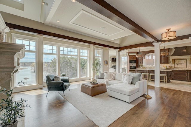 795 140th Ave, New Richmond, WI 54017 - living area featuring a chandelier, decorative columns, beam ceiling, wood finished floors, and recessed lighting