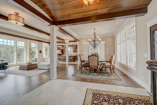 795 140th Ave, New Richmond, WI 54017 - dining space featuring healthy amount of natural light, ornate columns, baseboards, a chandelier, and crown molding