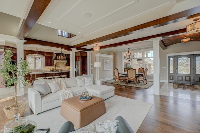795 140th Ave, New Richmond, WI 54017 - living room with decorative columns, a chandelier, beamed ceiling, wood finished floors, and baseboards