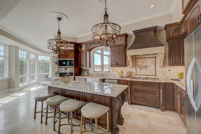 795 140th Ave, New Richmond, WI 54017 - kitchen featuring a chandelier, stainless steel appliances, backsplash, light stone countertops, and a center island with sink