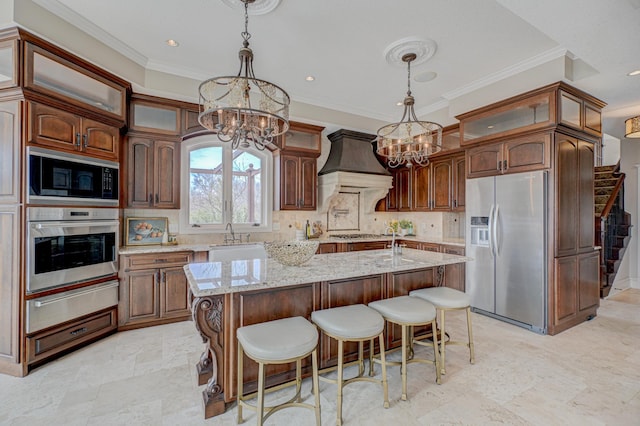 795 140th Ave, New Richmond, WI 54017 - kitchen with appliances with stainless steel finishes, a chandelier, a warming drawer, custom exhaust hood, and ornamental molding