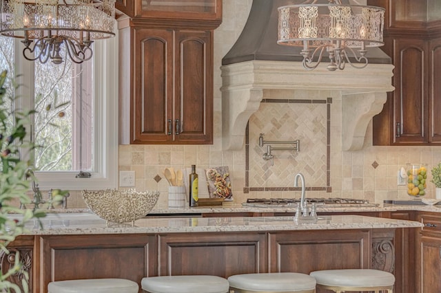 795 140th Ave, New Richmond, WI 54017 - kitchen with a chandelier, light stone counters, and tasteful backsplash