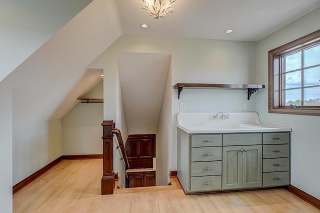 795 140th Ave, New Richmond, WI 54017 - bathroom featuring wood finished floors, lofted ceiling, baseboards, and vanity