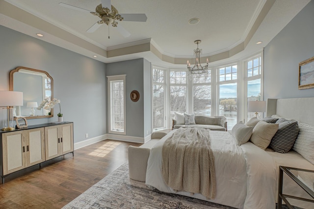 795 140th Ave, New Richmond, WI 54017 - bedroom featuring wood finished floors, a tray ceiling, ornamental molding, a chandelier, and baseboards
