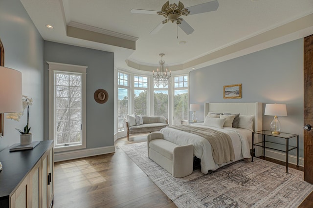 795 140th Ave, New Richmond, WI 54017 - bedroom with a raised ceiling, crown molding, a chandelier, multiple windows, and wood finished floors
