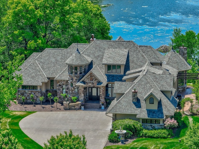 795 140th Ave, New Richmond, WI 54017 - french provincial home featuring stucco siding, a chimney, stone siding, and a water view