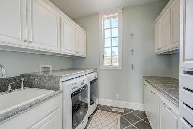 795 140th Ave, New Richmond, WI 54017 - laundry area with washing machine and clothes dryer, baseboards, cabinet space, and dark tile patterned floors
