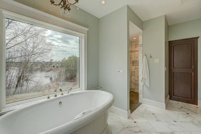 795 140th Ave, New Richmond, WI 54017 - bathroom featuring a freestanding bath, baseboards, a chandelier, walk in shower, and healthy amount of natural light
