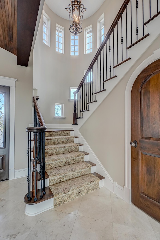 795 140th Ave, New Richmond, WI 54017 - foyer entrance with stairs, healthy amount of natural light, a towering ceiling, baseboards, and arched walkways