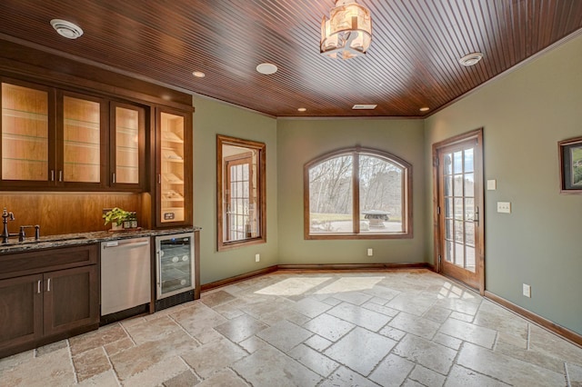 795 140th Ave, New Richmond, WI 54017 - indoor bar featuring beverage cooler, stainless steel dishwasher, ornamental molding, stone tile flooring, and baseboards