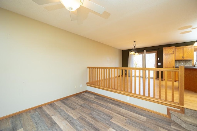 empty room with wood finished floors and baseboards