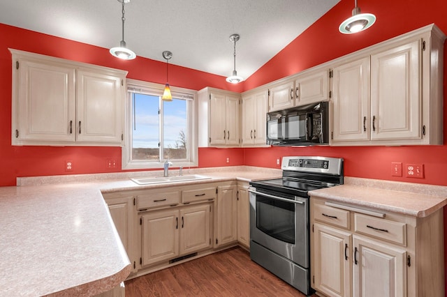kitchen featuring stainless steel electric range oven, black microwave, a sink, light countertops, and vaulted ceiling