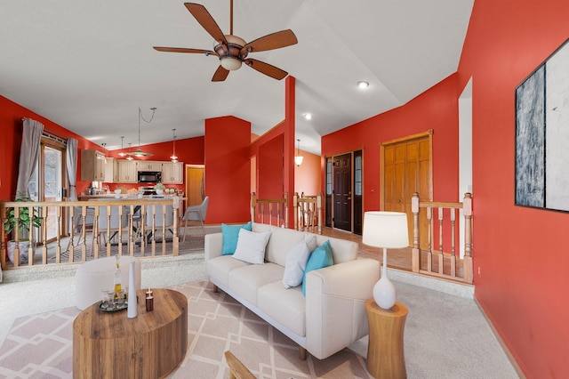 living room featuring lofted ceiling, baseboards, ceiling fan, light colored carpet, and recessed lighting