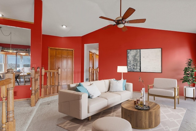 carpeted living room featuring a ceiling fan, baseboards, and vaulted ceiling