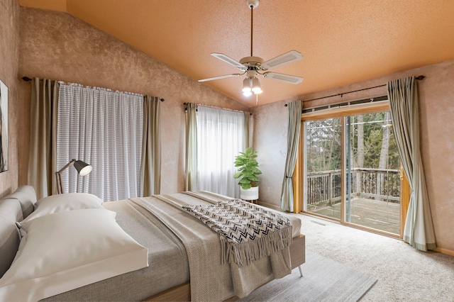 carpeted bedroom with access to outside, a ceiling fan, lofted ceiling, and a textured ceiling