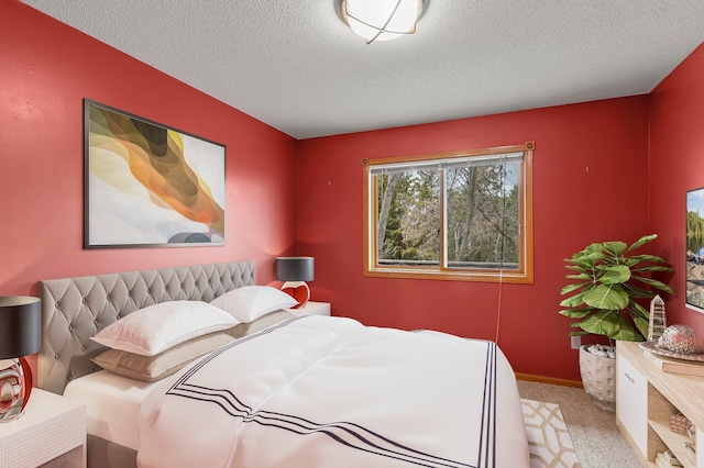 bedroom featuring a textured ceiling and carpet
